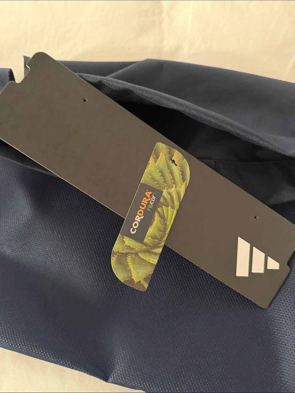 adidas Navy slim Backpack with White Logo and front zipper pocket